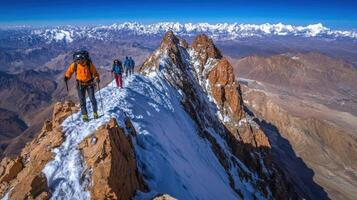 Hikers ascend a snowy mountain ridge in dramatic alpine scenery. photo