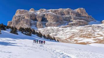 Snowy mountain vista with hikers ascending. photo