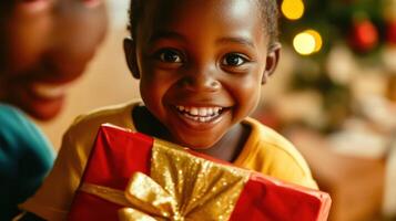 A joyful child holding a gift box during the holidays. photo