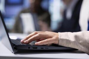 Factory shareholder typing on laptop, monitoring system performance. Industrial manufacturing plant executive using notebook to track energy production and efficiency, closeup photo