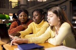 African american mentor guiding young learners through schoolwork and assignments, emphasizing diverse teaching methods and effective communication. Professor tutoring her pupils after class. photo