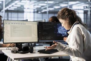 Frustrated technician annoyed after keyboard stopped working in data center while writing code on PC. Mad IT professional in server hub upset after computer peripherals got broken photo