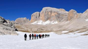 Group hiking across snowy mountain pass. photo