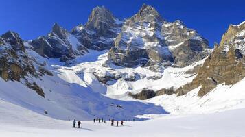 Snowy peaks and skiers in a dramatic winter landscape. photo