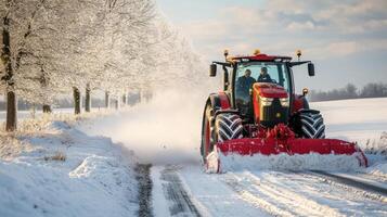 Red tractor plowing snow-covered rural road in winter. photo