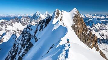 Majestic snowy mountain range with climber on summit ridge. photo