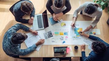 Diverse team collaborating around a table with charts and documents. photo