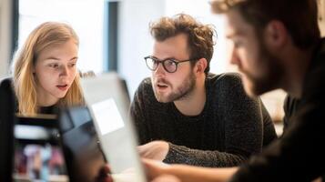 Focused group of young people collaborating on a project. photo
