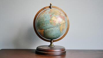Antique world globe resting on a wooden pedestal. photo