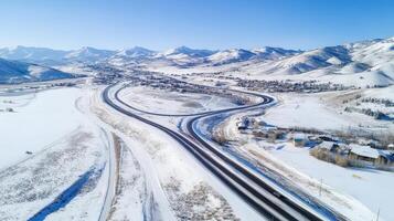 Aerial view of snowy mountain roads winding through a valley. photo