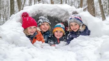 Four children nestled together in a snow cave. photo