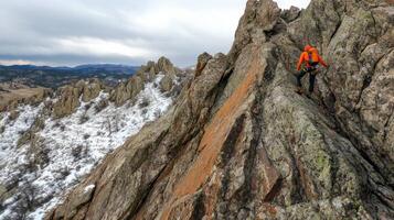 Adventurous climber traversing a rocky mountain ridge. photo