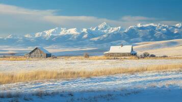 Snowy winter landscape with weathered farmhouses and mountains. photo