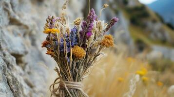 Close-up of a vibrant dried flower bouquet against a rocky backdrop. photo