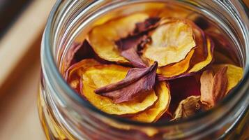Dried fruit and flower petals in a glass jar. photo