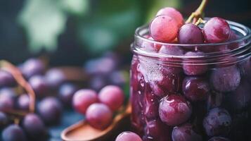 Close-up view of red grapes in a glass jar. photo