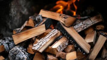Close-up view of stacked firewood in a fire pit. photo