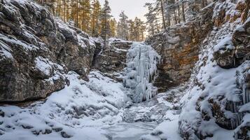 Snowy winter landscape with frozen waterfall cascading through rocky gorge. photo