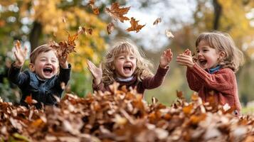 Three children playing in a pile of autumn leaves. photo