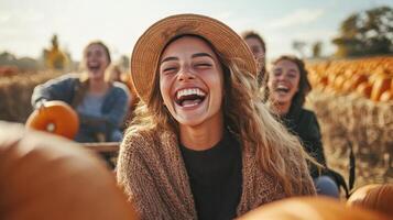 Group of friends laughing happily in a pumpkin patch. photo