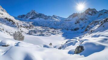 Snowy mountain valley with frozen lake and sunlight. photo