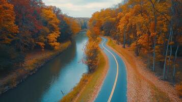 Autumnal scenery with winding road and river. photo