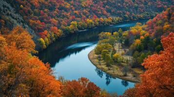 Serene autumnal river meanders through colorful foliage. photo