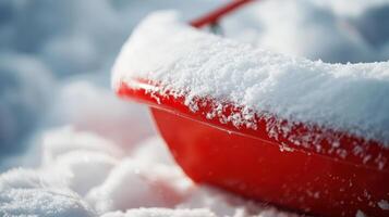 Close-up of a red sled covered in fresh snow. photo
