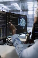 Computer scientists using machine learning applications to optimize server farm operations. Close up of IT professionals using PC to implement server virtualization in data center photo