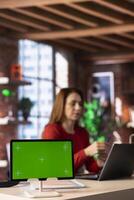 Person uses laptop for creative projects next to isolated copy space, creating designs while staying connected to the freelance platform. Woman focusing on research and multitasking. photo