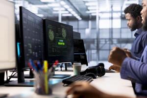 Developer receiving access granted notification while reconfiguring server farm, optimizing it. Worker ensures data center operates efficiently, happy after successfully eliminating all errors photo