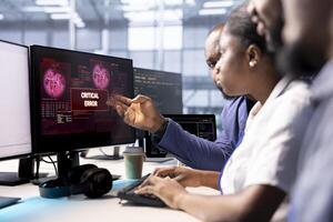 Cybersecurity coworkers monitoring security incidents affecting server hub network system, alerted by security breach alert, brainstorming ways to eliminate danger, protecting infrastructure photo