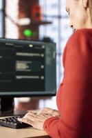 Mature woman interacting with a virtual assistant on her computer at home office, responses and smart automation to improve online communication. Data driven solutions. photo