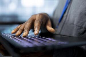 Admin in data center typing on notebook keyboard, using automation tools, doing predictive maintenance. Close up of IT specialist ensuring continuous uptime of server farm, managing data flows photo