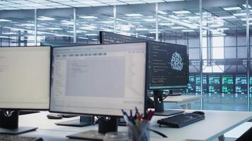 Close up of programming language on PC displays in server farm used for data processing requirements of AI workloads and neural network machine learning technology, panning shot photo