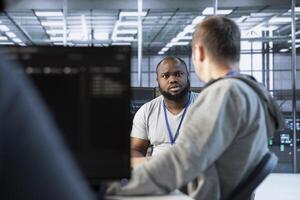 Manager admonishing developer after making error damaging high tech data center. Supervisor scolding IT staff member after doing mistake in server room affecting supercomputers photo