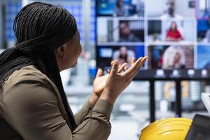 Investors interested in factory analyzing revenue streams during internet videocall. Closeup of shareholders in industrial plant doing teleconference to forecast returns, factoring in growth scenarios photo