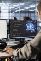 Admin implementing artificial intelligence cybersecurity measures to protect data center. Server hub AI professional monitoring and analyzing metrics with device to enhance operational effectiveness photo