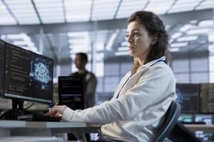 System administrator using artificial intelligence technology to optimize data center performance. Server room expert using AI tech to streamline operations and accurately forecast potential issues photo