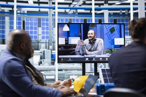 Investors evaluating solar panels manufacturing plant production during internet videocall before investing. Shareholders doing remote videoconference with managers to ask technical questions photo