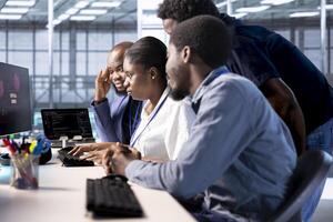 Team of engineers in server hub working together to investigate breach alerts, working to protect equipment from hacker. Colleagues doing brainstorming in data center to mitigate security risks photo