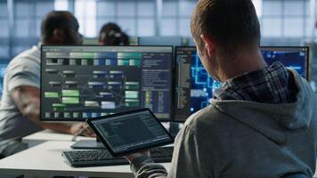 Computer scientist in data center uses artificial intelligence neural networks doing computing processes. IT specialist working on tablet with AI machine learning algorithms, camera A photo