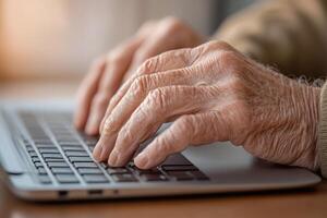 Elderly man learning to use a computer with patience and determination at home during daytime photo