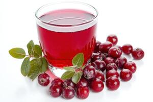 Fresh cranberry juice displayed in a glass with ripe cranberries and leaves on a white background photo
