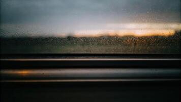 Inside a train a single hand on a condensation-covered window blurred landscape view at dusk photo