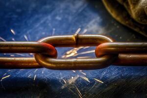 Forging fire closeup of a redhot chain in a blacksmith's workshop with sparks flying photo