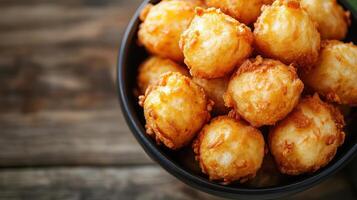 Golden donuts in a bowl, close-up view. photo