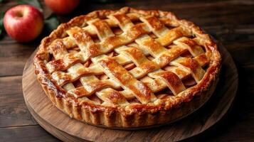 A pie with lattice on top of a wooden table photo