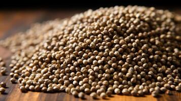 Pile of coriander seeds on a wooden surface. photo
