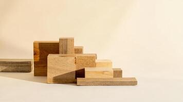 Wooden geometric blocks arranged on a beige background create abstract modern shapes photo